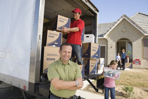 Local Chelsea moving team navigating tight urban streets with a van
