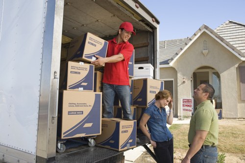 Removal team handling fragile boxes during a house move in Chelsea