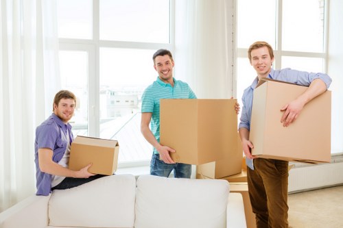 Crew handling sofas and tables during furniture pick-up in Chelsea